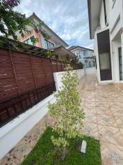 Outdoor area with tiled pathway and greenery