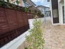 Outdoor area with tiled pathway and greenery