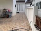 Outdoor area with tiled flooring and garden hose