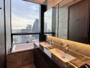 Modern bathroom with city view from the window