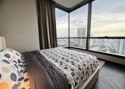 Modern bedroom with large windows and city view