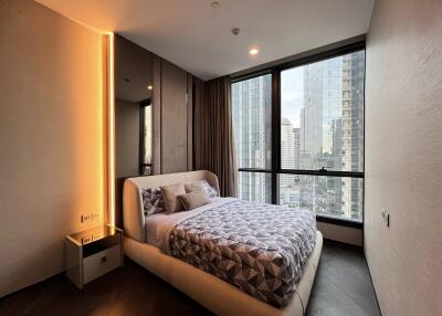 Modern bedroom with large windows and city view