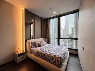 Modern bedroom with large windows and city view