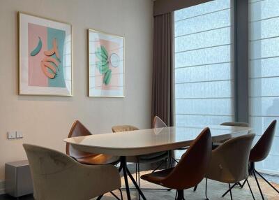 Modern dining area with stylish chairs and artwork