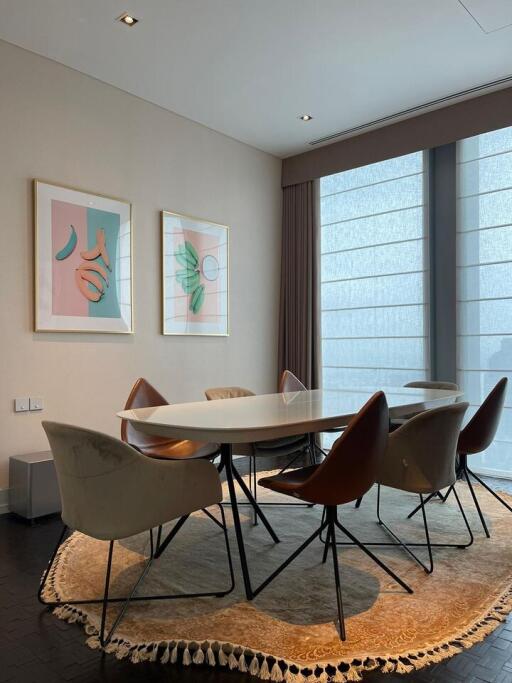 Modern dining area with stylish chairs and artwork