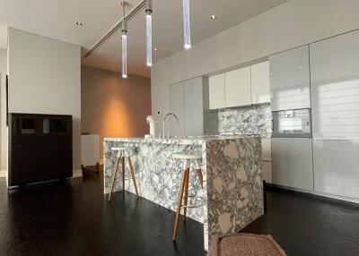 Modern kitchen with marble island and contemporary pendant lights