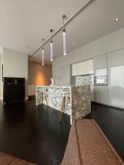 Modern kitchen with marble island and contemporary pendant lights