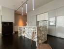 Modern kitchen with marble island and contemporary pendant lights