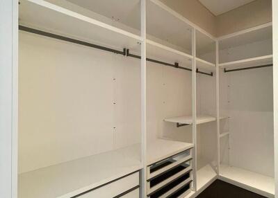 Spacious walk-in closet with built-in shelving and hanging bars