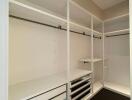 Spacious walk-in closet with built-in shelving and hanging bars