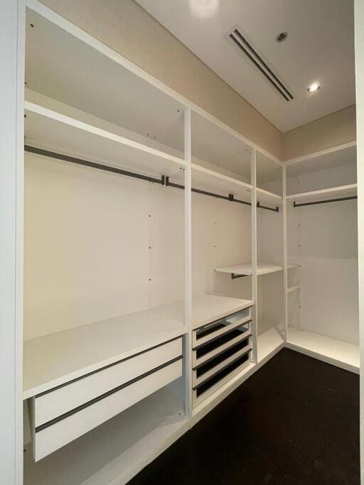 Spacious walk-in closet with built-in shelving and hanging bars