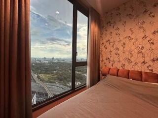 Bedroom with large window and city view