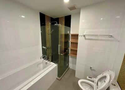 Modern bathroom with bathtub, shower, and bidet