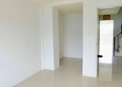 spacious empty living area with stairs visible