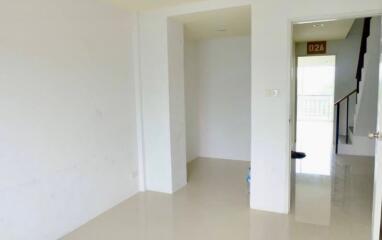 spacious empty living area with stairs visible