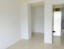 spacious empty living area with stairs visible