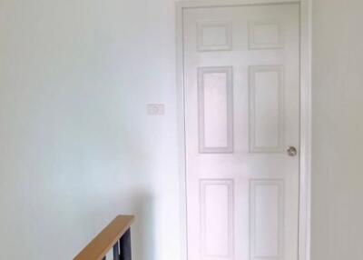 Staircase leading to a white door with room number 03A