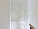 A white door with six panels in a hallway