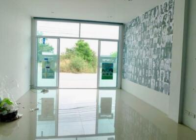 Spacious living room with large window and decorative wall