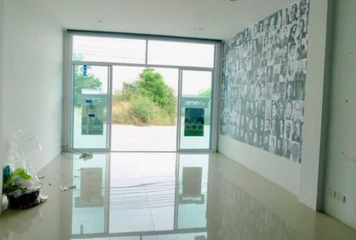 Spacious living room with large window and decorative wall