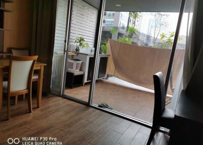 Balcony area with sliding glass doors, partially view of dining area