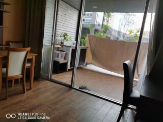 Balcony area with sliding glass doors, partially view of dining area