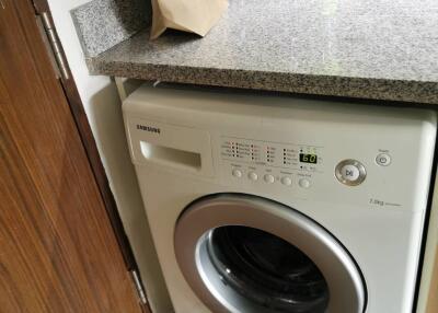 Washing machine in a compact laundry area