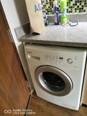 Washing machine in a compact laundry area