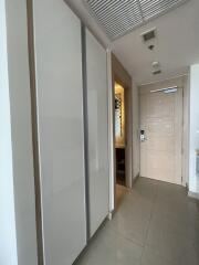 Hallway with storage and entry door