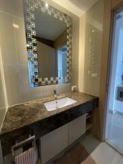 Modern bathroom with large mirror and marble countertop