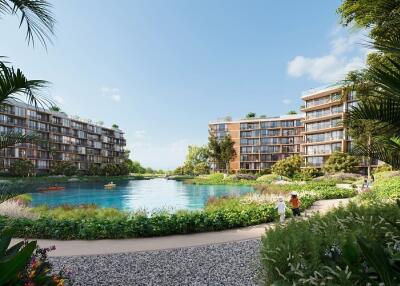 View of modern residential buildings with a central lake and landscaped greenery