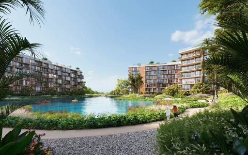 View of modern residential buildings with a central lake and landscaped greenery