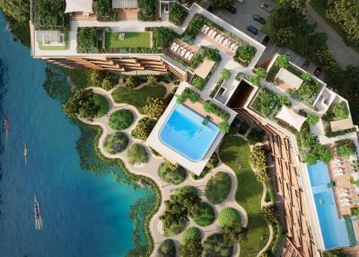 Aerial view of a modern apartment complex with outdoor swimming pools and lush greenery