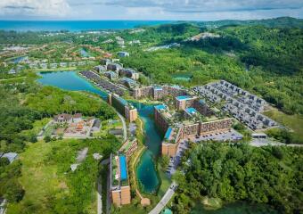 Aerial view of residential complex with green surroundings