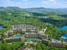 Aerial view of a large residential complex surrounded by greenery and water bodies