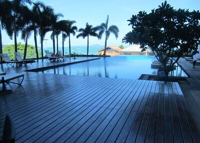 luxurious swimming pool with deck and lounge chairs