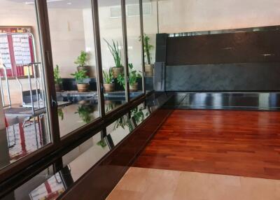 Entrance lobby with glass walls and indoor plants