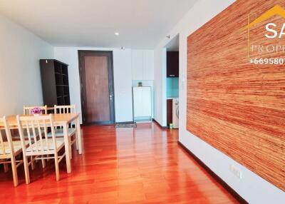 Living area with dining table and wooden flooring