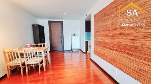 Living area with dining table and wooden flooring