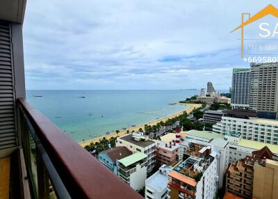 Balcony with a view of the ocean and nearby buildings