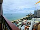 Balcony with a view of the ocean and nearby buildings