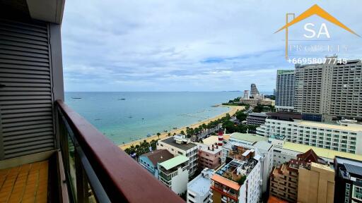 Balcony with a view of the ocean and nearby buildings