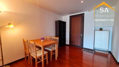 wooden dining area with table and chairs