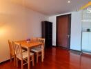 wooden dining area with table and chairs