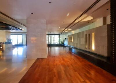 Spacious hallway with wooden and marble flooring