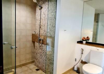 Modern bathroom with glass shower and neutral tiles