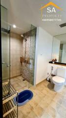 Modern bathroom with glass shower and neutral tiles