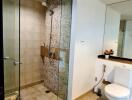 Modern bathroom with glass shower and neutral tiles