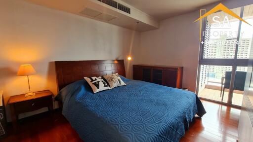 Well-lit bedroom with a large bed and balcony access