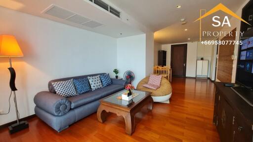 Living room with sofa, coffee table, and TV